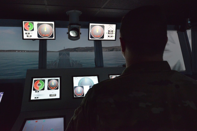U.S. Army Sgt. James Barton, Maritime and Intermodal Training Department student, looks down the bridge of a logistics support vessel simulator as shots are fired at the Maritime and Intermodal Training Department Simulation Center on Fort Eustis, Va., May 31, 2016.  The simulation center allows instructors to control various scenarios their students could encounter on the job, such as direct enemy fire and natural disasters, in a safe and controlled environment. (U.S. Air Force photo by Staff Sgt. Natasha Stannard)