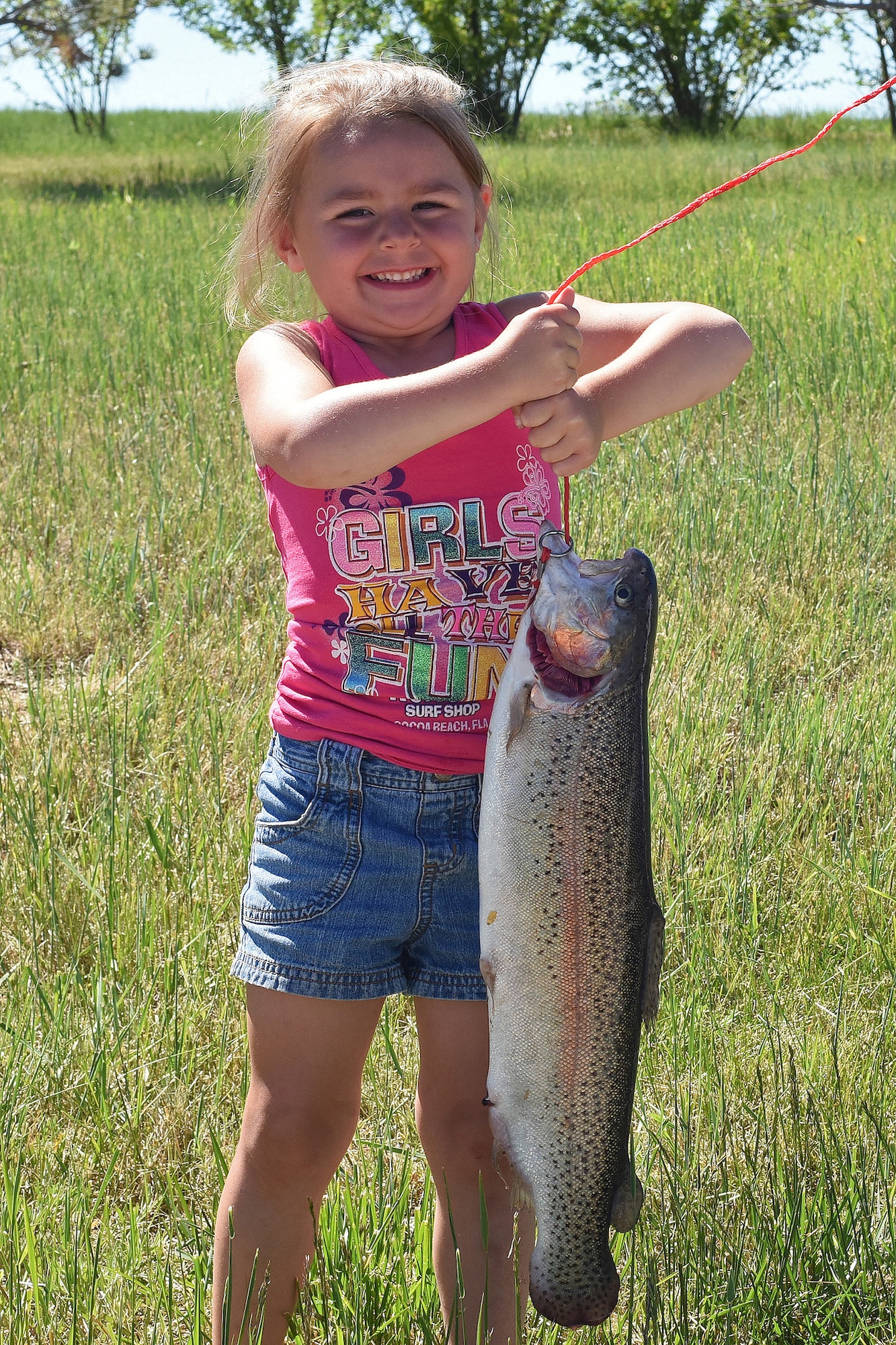 Ella shows her catch at the Kid’s Fishing Day event June 4, 2016, at Malmstrom Air Force Base, Mont. Pow Wow Pond was filled with more than 800 pounds of fish. (U.S. Air Force photo/ Senior Airman Jaeda Tookes)
