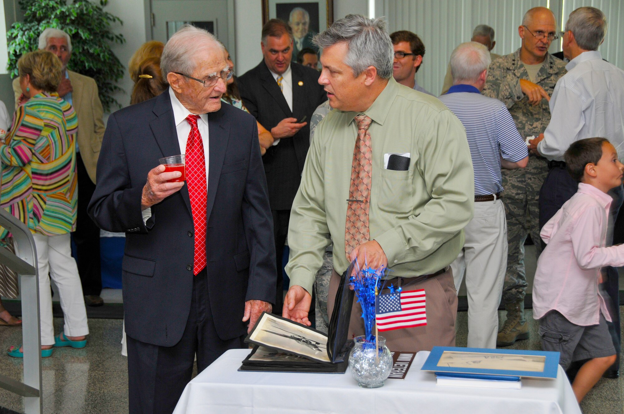 AEDC Historian Christopher Rumley speaks with Retired Maj. Ike Farrar, left, about his memories of World War II during a military appreciation reception held at Arnold Air Force Base in 2014 in honor of Farrar's contributions to the Air Force. (U.S. Air Force photo/Rick Goodfriend)