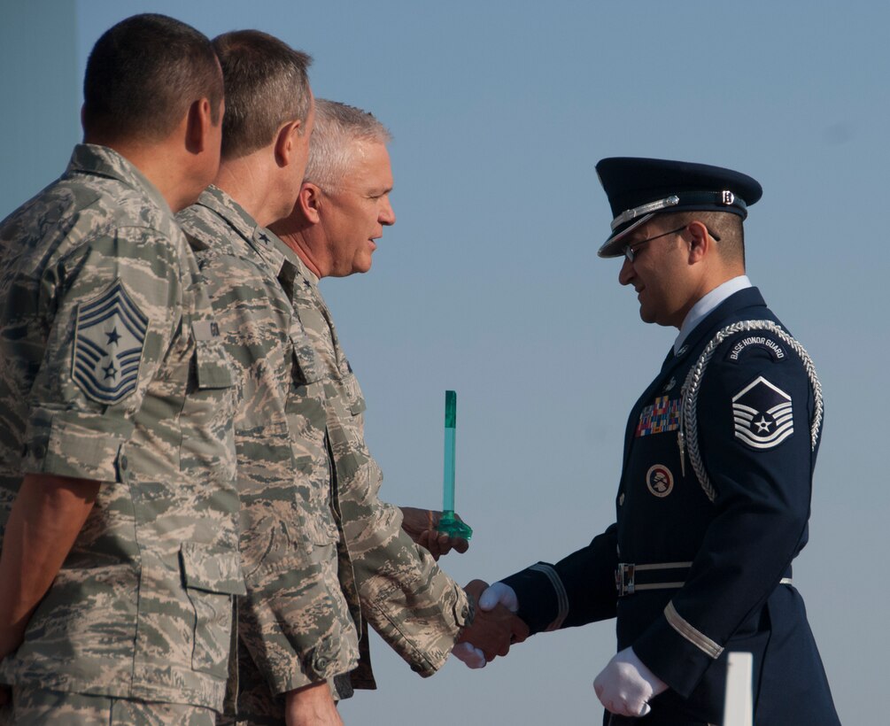Master Sgt. Virgil Mendivil, 162nd Wing honor guard, shakes Arizona Air National Guard commander Maj. Gen. Edward Maxwell's hand June 5, 2016, as he accepts the award for Honor Guard Member of the Year, which was posthumously awarded, on behalf of Master Sgt. Frank Enfinger. Individual and team awards were given to recognize the distinctive accomplishments of Wing members in 2015. (U.S. Air National Guard photo by Staff Sgt. Greg Ferreira)   