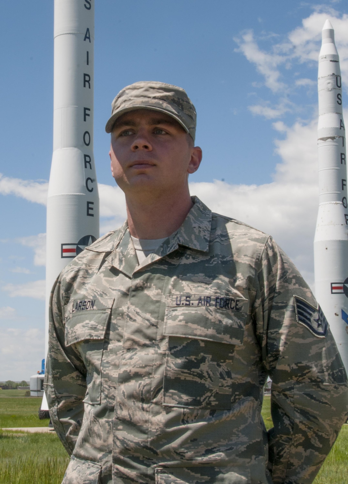 Staff Sgt. Alex Larson, 90th Medical Operations Squadron flight and operations medicine technician, poses in front of the missile display on F.E. Warren Air Force Base, Wyo., June 1, 2016. Larson is slated to attend Officer Training School in early 2017, then attend technical school to become a missileer. (U.S. Air Force photo by Senior Airman Jason Wiese)