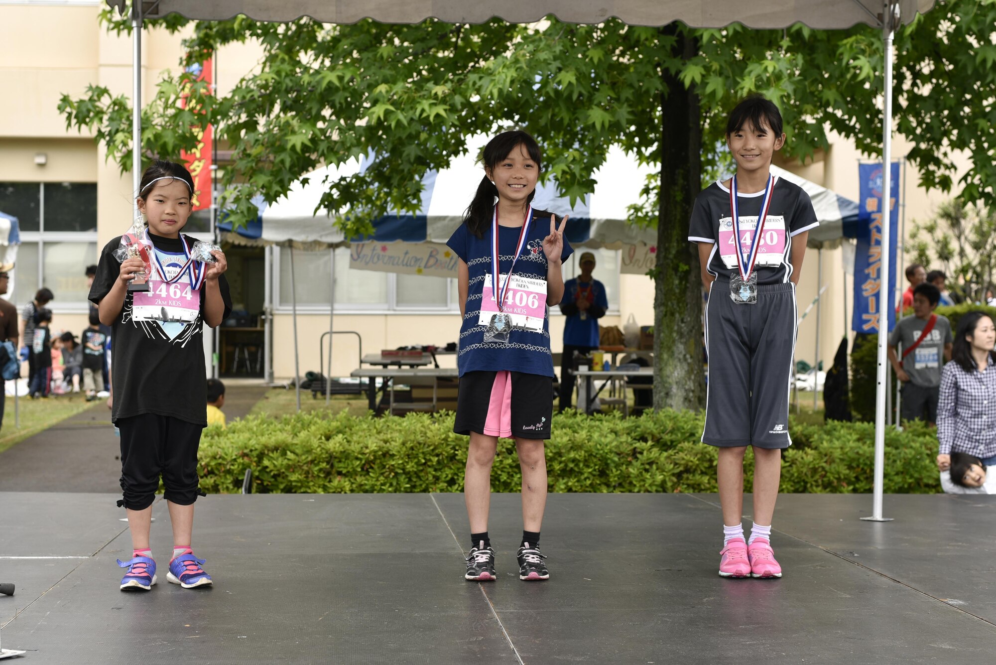 Award winners sport their trophies from the kids 2k race during the 2016 Ekiden Run at Yokota Air Base, Japan, June 5, 2016. Japanese runners came to Yokota to participate in the run, many of them in costumes. (U.S. Air Force photo by Staff Sgt. Michael Washburn/Released)