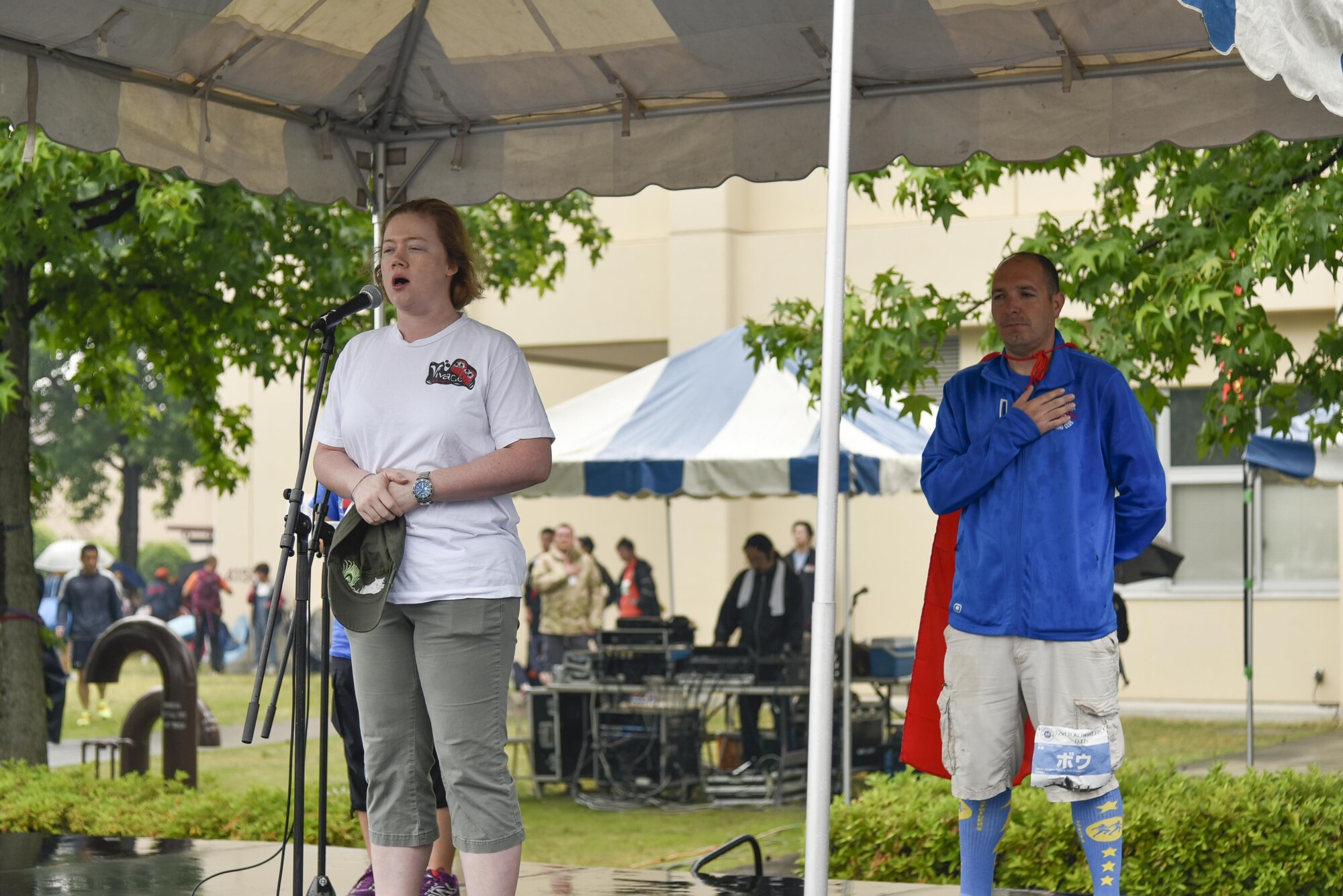 U.S. Navy Lt. Jamie Collyer sings the Japanese and U.S. National Anthem during opening ceremonies at the 2016 Ekiden Run at Yokota Air Base, Japan, June 5, 2016. The Ekiden Run consisted of a 2k, 8k and 20k race. (U.S. Air Force photo by Staff Sgt. Michael Washburn/Released)