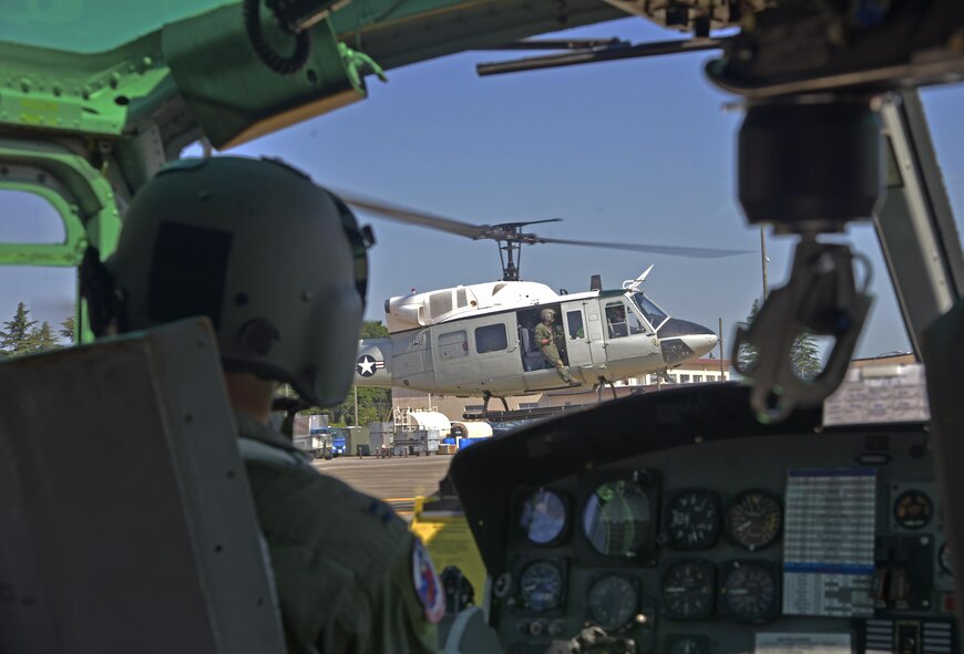Members of the 459th Airlift Squadron take off in an UH-1N Iroquois for a formation flight at Yokota Air Base, Japan, June 3, 2016. The formation flight provided the aircrew with an opportunity to practice flight procedures and prepare for real-world missions. (U.S. Air Force photo by Senior Airman David Owsianka/Released)