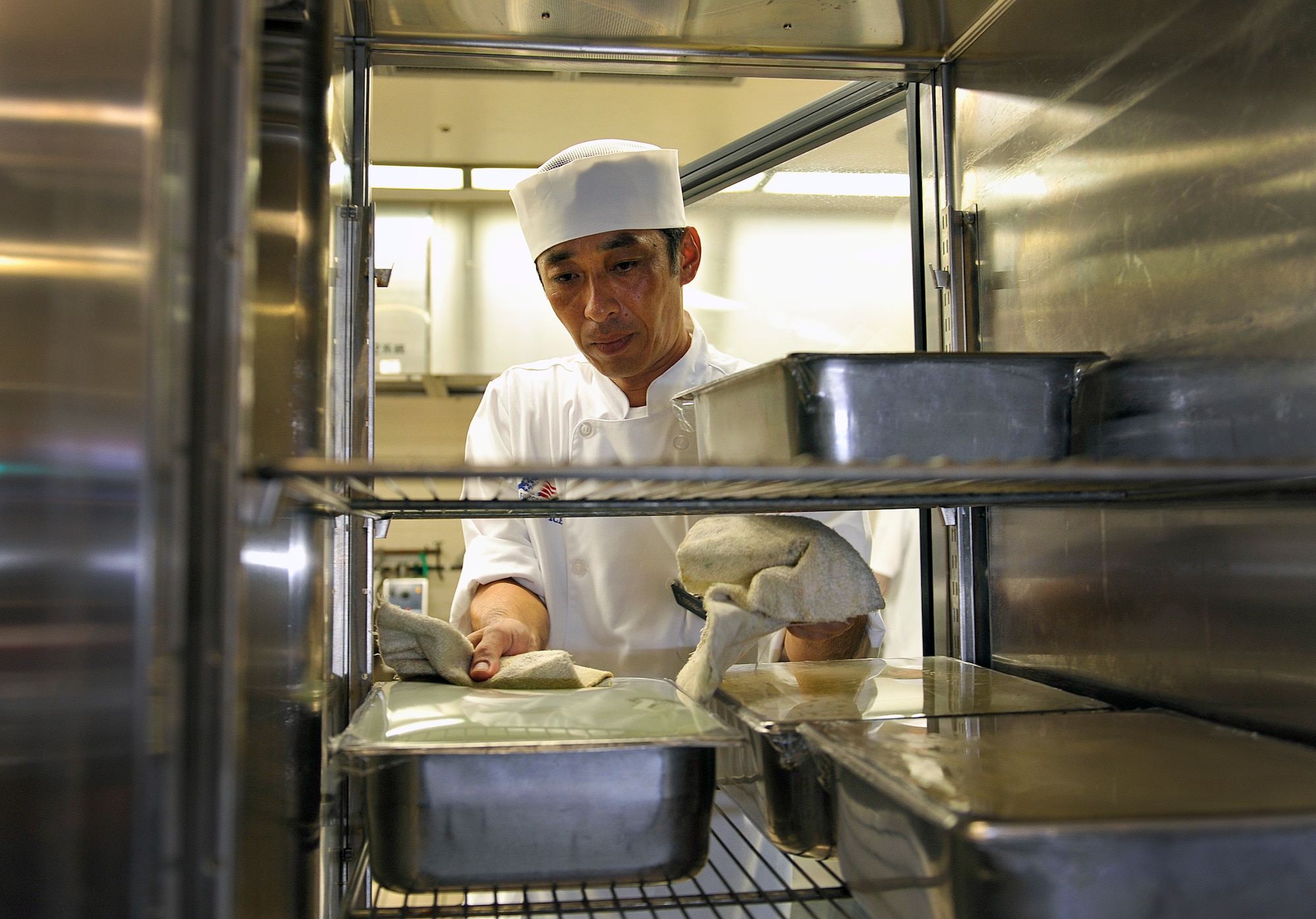 Takashi Seragaki, 18th Force Support Squadron cook, stores lunch ingredients at the Marshall Dining Facility, June 3, 2016, at Kadena Air Base, Japan. During Seragaki's days off, he plays golf, goes fishing and practices guitar to prepare for his annual performance at the Bounenkai party (year-end party). (U.S. Air Force photo by Naoto Anazawa)
