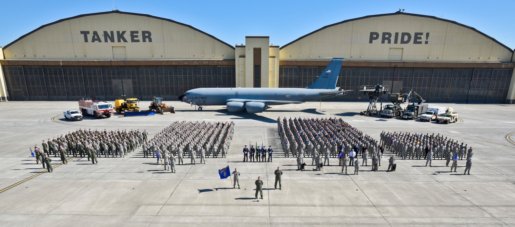 92nd Air Refueling Wing personnel stand proudly for the annual wing photo in front of building 2050, May 2016. Historically, wing photos have been taken in front of the adorned Tanker Pride, because the building is arguably the anchor and icon of Fairchild. In addition, wing change of commands are conducted on the other side of building 2050 where it reads Global Reach For America. (U.S. Air Force photo/Airman 1st Class Taylor Shelton)