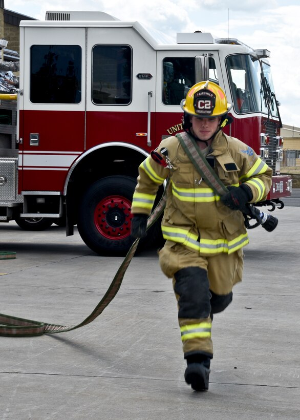 Airman 1st Class Shawn Mercer, 92nd Civil Engineer Squadron firefighter, runs with a fire hose May 25, 2016, at Fairchild Air Force Base, Wash. “I learned everything about shooting water from the trucks to being able to protect myself from fire,” Mercer said. “What we learn in technical school doesn’t always apply to where we are, so on the job training is important.” (U.S. Air Force photo/Airman 1st Class Taylor Shelton) 