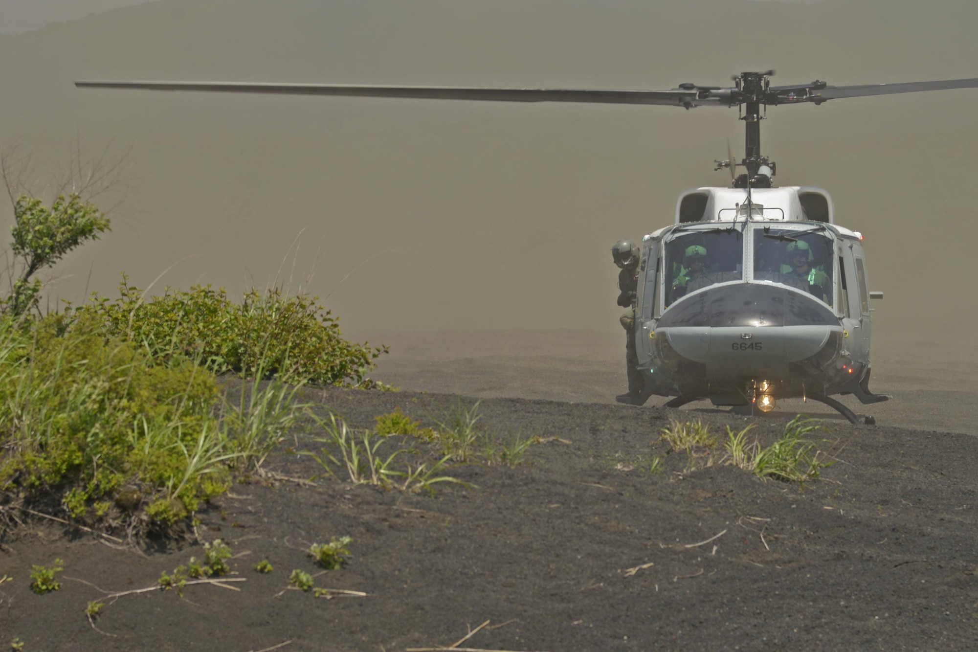 Pilots of a UH-1N Iroquois with the 459th Airlift Squadron land at a drop zone near Mt. Fuji, Japan, June 3, 2016. The formation flight allowed the aircraft to fly together while gaining proficiency in different landing environments such as an airfield, grass field and a mountain landing zone. (U.S. Air Force photo by Senior Airman David Owsianka/Released)