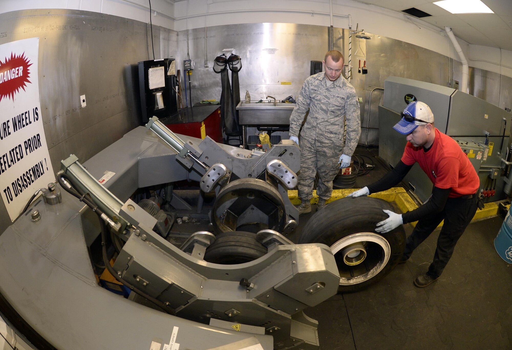 Tech. Sgt. James Speicher, right, an air reserve technician with the 419th Maintenance Squadron, rolls an F-35 Lightning II wheel into a tire changing machine May 20, 2016, while Senior Airman Joseph Sprowls, of the 388th Maintenance Squadron, looks on in the wheel and tire shop at Hill Air Force Base, Utah. The machine depicted is a legacy tool which has been adapted via a fabricated bead breaker to be used in changing F-35 tires. (U.S. Air Force photo/Todd Cromar)