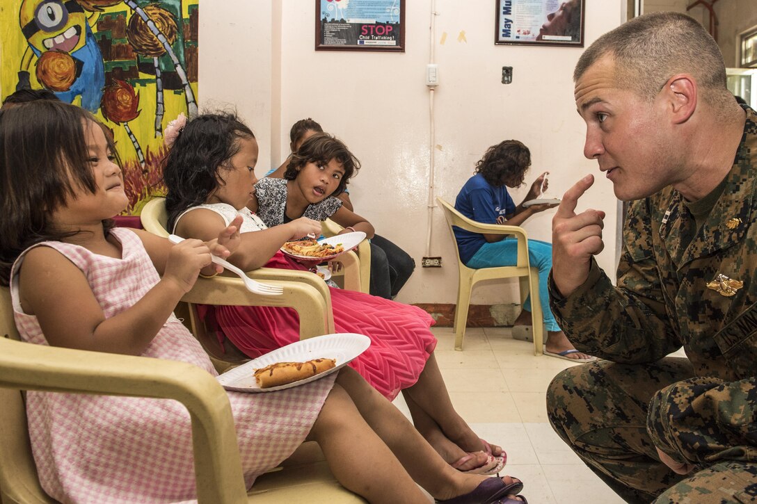 Navy Lt. Derek Chamberlain bonds with a young resident at a social development center in Subic Bay, Philippines, June 6, 2016, during a Project Handclasp outreach program as part of Cooperation Afloat Readiness and Training Philippines 2016. The annual maritime exercises include nine partner nations. Navy photo by Petty Officer 3rd Class Joshua Fulton