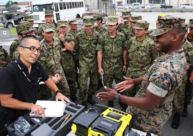 U.S. Marine Corps Cpl. Andrew Jackson, recon team leader from 3rd Marine Division, Chemical, Biological, Radiological and Nuclear defense platoon, Headquarters Battalion, III Marine Expeditionary Force, shows members of the Japan Ground Self-Defense Force, Nuclear, Biological, Chemical unit with the 13th Brigade in Kaita, Hiroshima, assessment and consequence management equipment during exercise Habu Sentinel 16 at Disaster Village, Marine Corps Air Station Iwakuni, Japan, June 1, 2016. Provided to each major subordinate command for their platoons to utilize, the Marine Air Ground Task Force ACM set provides the division with enhanced CBRN proficiencies above those available to subordinate units, including CBRN technical rescue and the necessary response capabilities to support national military strategy for countering weapons of mass destruction and other contingency operations. As the annual capstone exercise for the division’s response element, this event encompasses multiple objectives specific to CBRN response and validates unit standard operating procedures in an unfamiliar training environment. (U.S. Marine Corps photo by Sgt. Jessica Quezada/Released)