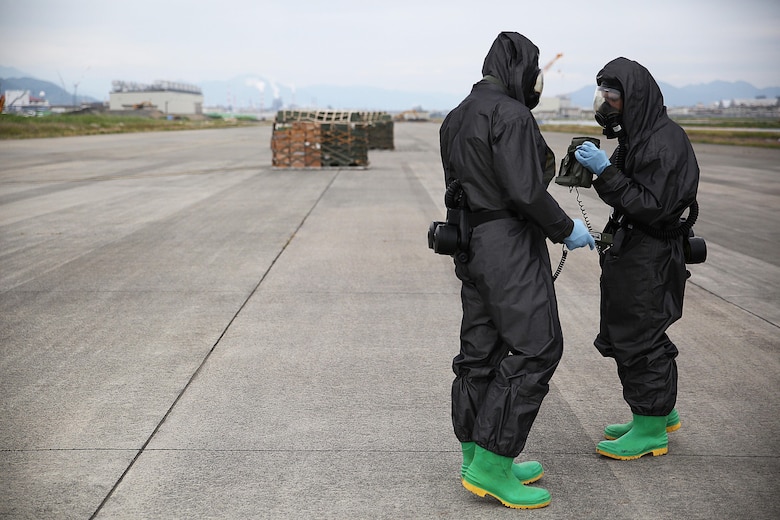 U.S. Marines from 3rd Marine Division, Chemical, Biological, Radiological and Nuclear defense platoon, Headquarters Battalion, III Marine Expeditionary Force, prepare to respond to contaminated cargo during exercise Habu Sentinel 16 at Marine Corps Air Station Iwakuni, Japan, June 7, 2016. Marine Aerial Refueler Transport Squadron (VMGR) 152, stationed at MCAS Iwakuni, assisted in the scenario by providing a taxiway combat off-load. Pallets suspected of radiological contamination slid from the cargo bay of a KC-130J Super Hercules onto the taxiway where CBRN Marines were staged nearby in order to respond swiftly and effectively.  As the annual capstone exercise for the division’s response element, this event encompasses multiple objectives specific to CBRN response and validates unit standard operating procedures in an unfamiliar training environment. (U.S. Marine Corps photo by Sgt. Jessica Quezada/Released)