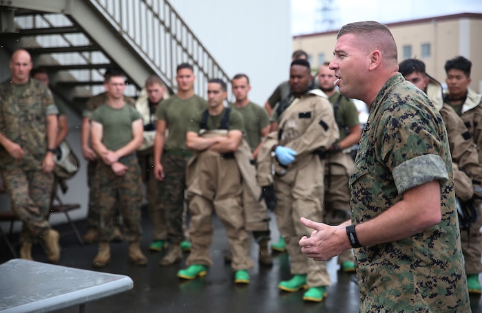 U.S. Marine Corps Chief Warrant Officer Christopher Joy, Chemical, Biological, Radiological and Nuclear defense officer with 3rd Marine Division, CBRN defense platoon, Headquarters Battalion, III Marine Expeditionary Force, mentors his Marines before they respond to a simulated CBRN threat during exercise Habu Sentinel  16, at Disaster Village, Marine Corps Air Station Iwakuni, Japan, June 6, 2016. As the annual capstone exercise for the division’s response element, this event encompasses multiple objectives specific to CBRN response and validates unit standard operating procedures in an unfamiliar training environment. (U.S. Marine Corps photo by Sgt. Jessica Quezada/Released)