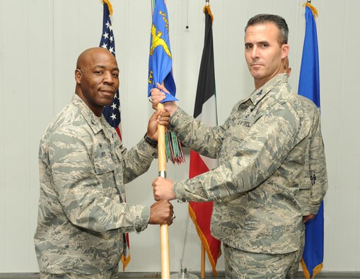 Col. Zachary Zeiner assumes command of the 387th Air Expeditionary Group and receives the guidon from Col. Clarence Lukes Jr., 386th Air Expeditionary Wing commander, during a change of command ceremony at an undisclosed location in Southwest Asia, June 7, 2016. Prior to assuming command of the 387 AEG, Zeiner served as the Deputy Command Center Director for U.S. Northern Command at Peterson Air Force Base, Colo. Zeiner will be responsible for a group that provides support for base operations, coordination with host nation partners, and administration of the Joint Expeditionary Tasked individual augmentees in the area of responsibility. (U.S. Air Force photo by Senior Airman Zachary Kee)