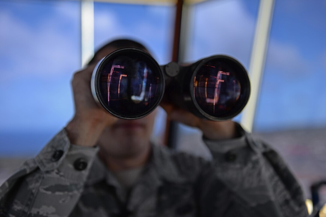 Staff Sgt. Nicholas Barsenas, 36th Operations Support Squadron air traffic controller, scans the flightline June 2, 2016, at Andersen Air Force Base, Guam. Air traffic controllers support U.S. Pacific Command's continuous bomber presence, which deters potential adversaries and provides reassurance to allies and partners that the U.S. is capable to defend its national security interests in the Indo-Asia-Pacific region. (U.S. Air Force photo by Airman 1st Class Jacob Skovo)