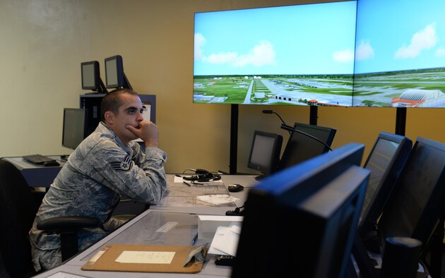 Staff Sgt. Nicholas Barsenas, 36th Operations Support Squadron air traffic controller, uses a tower simulation system June 2, 2016, at Andersen Air Force Base, Guam. Air traffic controllers train during normal operations to handle heavy flightline traffic during exercises including Cope North and Valiant Shield. (U.S. Air Force photo by Airman 1st Class Jacob Skovo)
