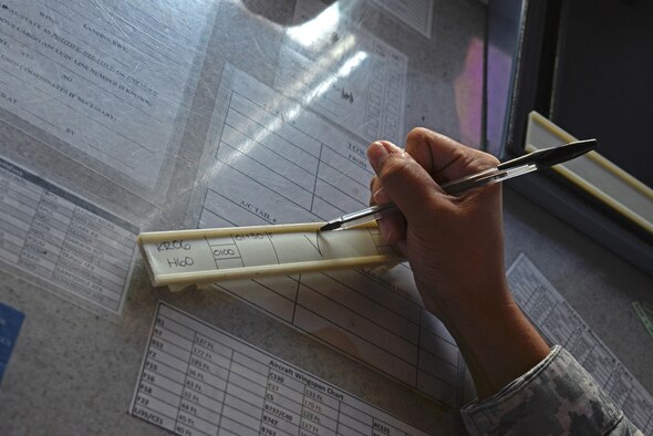Staff Sgt. Tiffany Degracia, 36th Operations Support Squadron air traffic controller, records flight data for a departing helicopter June 2, 2016, at Andersen Air Force Base, Guam. Air traffic controllers support various aircraft to include the MH-60S Seahawk operated by Helicopter Sea Combat Squadron Two Five and deployed aircraft such as the B-52 Stratofortress. (U.S. Air Force photo by Airman 1st Class Jacob Skovo)