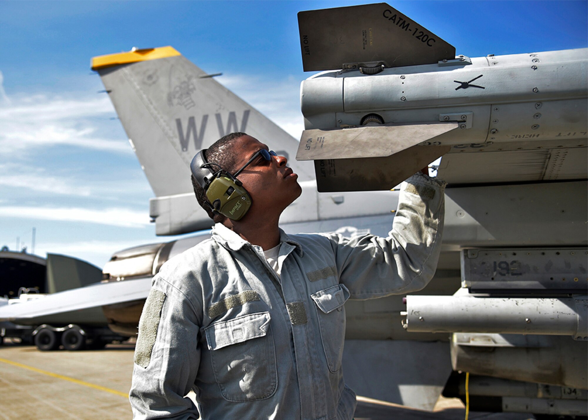 U.S. Air Force Staff Sgt. Miles Smith, an armament systems specialist with the 35th Aircraft Maintenance Squadron, inspects a fin on an AIM-120 advanced medium-range air-to-air missile at Misawa Air Base, Japan, June 6, 2016. Smith and his weapons loading team were honing their skills during a three-day surge exercise to practice wartime capabilities and procedures. Surges focus on 24-hour operations and performing under the stress and time crunch of a simulated combat zone. (U.S. Air Force photo by Senior Airman Deana Heitzman)