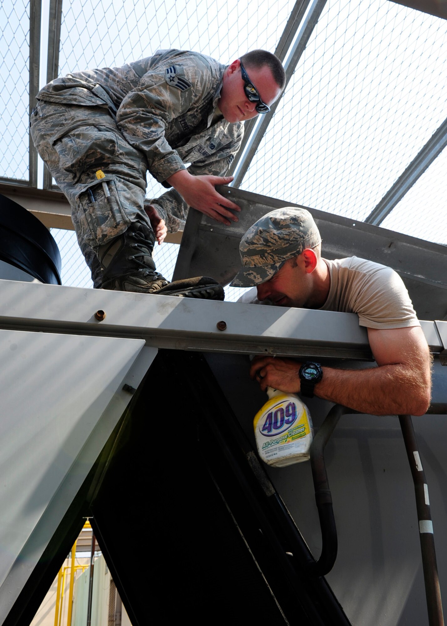 Senior Airman Thomas LeSuer and Staff Sgt. Elvis Pabon, 8th Civil Engineer Squadron Heating, Ventilation, and Air Conditioning journeyman, check for leaks in an air refrigerating machine at the base theater June 7, 2016. The Wolf Pack relies on the individuals from the HVAC shop to help keep the mission going. (U.S. Air Force photo/Staff Sgt. Chelsea Browning)
