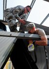 Senior Airman Thomas LeSuer and Staff Sgt. Elvis Pabon, 8th Civil Engineer Squadron Heating, Ventilation, and Air Conditioning journeyman, check for leaks in an air refrigerating machine at the base theater June 7, 2016. The Wolf Pack relies on the individuals from the HVAC shop to help keep the mission going. (U.S. Air Force photo/Staff Sgt. Chelsea Browning)