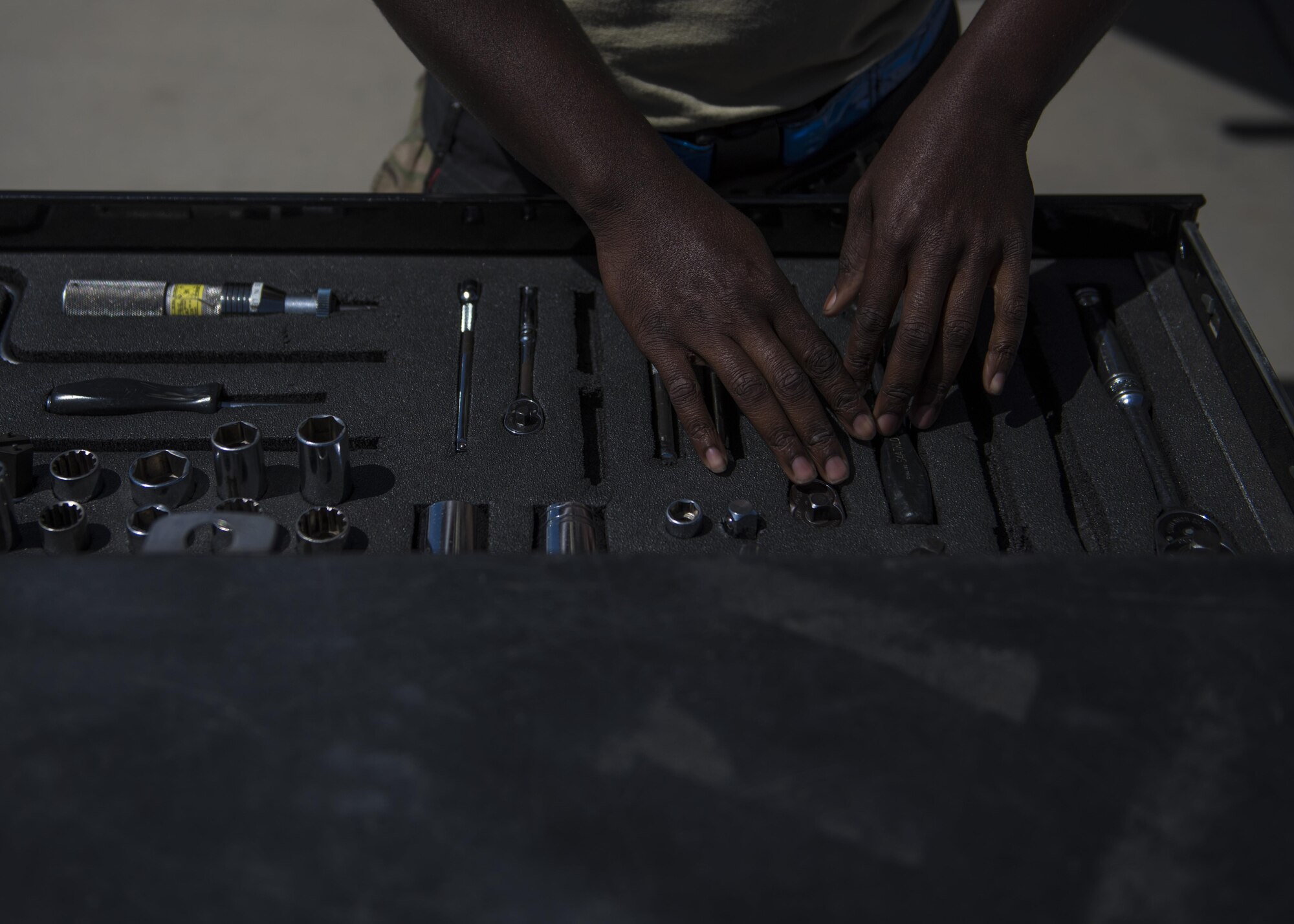 Senior Airman Clarence Williams, 455th Expeditionary Aircraft Maintenance Squadron weapons maintainer, prepares tools to load two GBU (Guided Bomb Unit)-54 on an F-16C Fighting Falcon during routine weapons upload at Bagram Airfield, Afghanistan, June 07, 2016. Airmen with the 455th EAMXS weapons flight ensure the aircraft are armed, combat ready, and fully operational before every F-16 take off. (U.S. Air Force photo by Senior Airman Justyn M. Freeman)