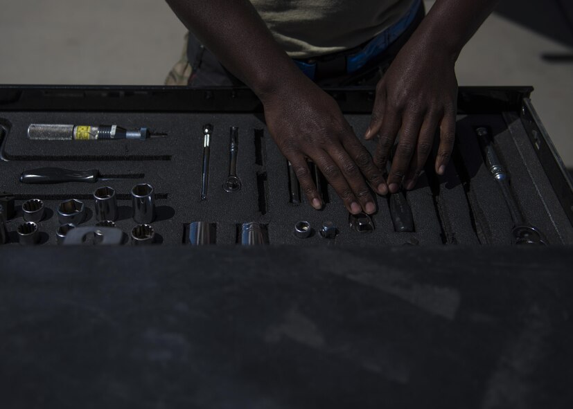 Senior Airman Clarence Williams, 455th Expeditionary Aircraft Maintenance Squadron weapons maintainer, prepares tools to load two GBU (Guided Bomb Unit)-54 on an F-16C Fighting Falcon during routine weapons upload at Bagram Airfield, Afghanistan, June 07, 2016. Airmen with the 455th EAMXS weapons flight ensure the aircraft are armed, combat ready, and fully operational before every F-16 take off. (U.S. Air Force photo by Senior Airman Justyn M. Freeman)