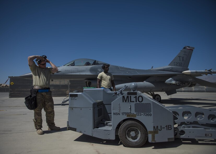 Technical Sgt. Joseph McCullough (left) and Senior Airman Clarence Williams (right), 455th Expeditionary Aircraft Maintenance Squadron weapons maintainers, prepare to load two GBU (Guided Bomb Unit)-54 on an F-16C Fighting Falcon during routine upload at Bagram Airfield, Afghanistan, June 07, 2016. Load crews work endlessly to preserve our nation’s security by supporting combat-ready forces for anti-terrorism efforts. (U.S. Air Force photo by Senior Airman Justyn M. Freeman)
