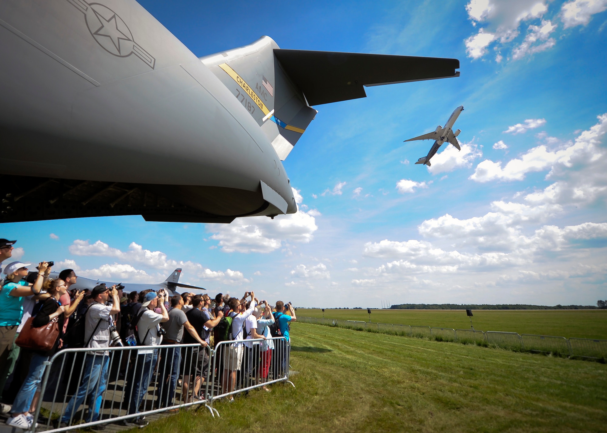 A crowd of onlookers gather to catch a view of the festivities beneath a C-17 Globemaster III June 3, 2016, during the Berlin Air Show, Germany. The show had approximately 230,000 visitors and exhibitors from more than 65 countries. (U.S. Air Force photo by Senior Airman Tom Brading)
