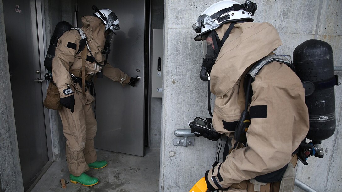 U.S. Marines from 3rd Marine Division, Chemical, Biological, Radiological and Nuclear defense platoon, Headquarters Battalion, III Marine Expeditionary Force, prepare to enter a room suspected of hazardous materials during exercise Habu Sentinel 16 at Disaster Village, Marine Corps Air Station Iwakuni, Japan, June 7, 2016. As the annual capstone exercise for the division’s response element, this event encompasses multiple objectives specific to CBRN response and validates unit standard operating procedures in an unfamiliar training environment.