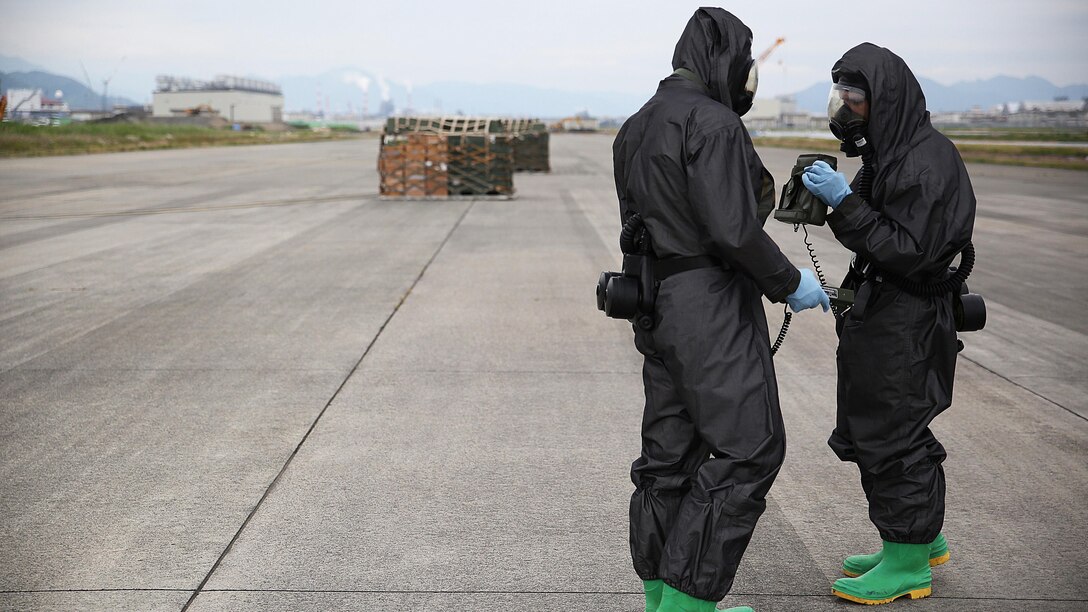 U.S. Marines from 3rd Marine Division, Chemical, Biological, Radiological and Nuclear defense platoon, Headquarters Battalion, III Marine Expeditionary Force, prepare to respond to contaminated cargo during exercise Habu Sentinel 16 at Marine Corps Air Station Iwakuni, Japan, June 7, 2016. Marine Aerial Refueler Transport Squadron 152, stationed at MCAS Iwakuni, assisted in the scenario by providing a taxiway combat off-load. Pallets suspected of radiological contamination slid from the cargo bay of a KC-130J Super Hercules onto the taxiway where CBRN Marines were staged nearby in order to respond swiftly and effectively.  As the annual capstone exercise for the division’s response element, this event encompasses multiple objectives specific to CBRN response and validates unit standard operating procedures in an unfamiliar training environment.