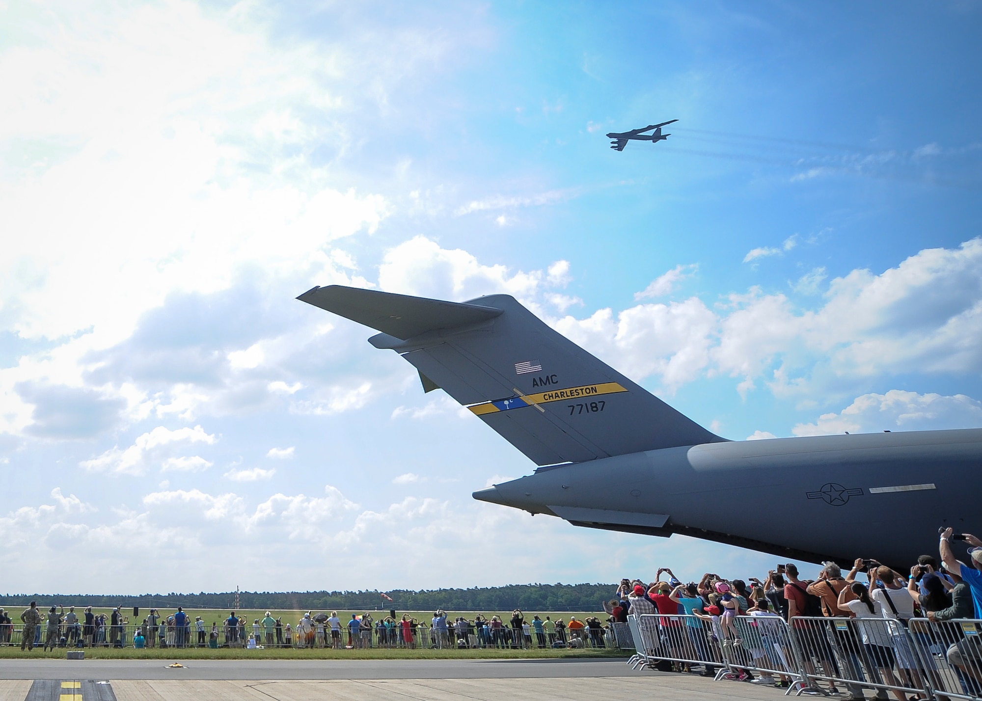 B-52 Stratofortress flies over The Spirit of Berlin C-17 Globemaster III June 4 during the 2016 Berlin Air Show, Germany. The show had approximately 230,000 visitors and exhibitors from more than 65 countries. (U.S. Air Force photo by Senior Airman Tom Brading)