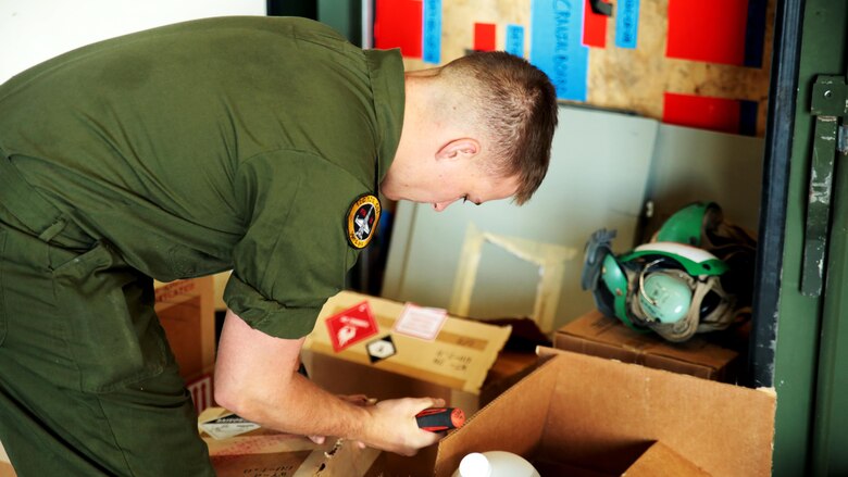 U.S. Marine Corps Cpl. John Kilmartin, an air frame and corrosion control maintainer with Marine Fighter Attack Squadron 314, unpacks paint and anti-corrosion chemicals for use during exercise Red Flag-Alaska 16-2 at Eielson Air Force Base, Alaska, June 4, 2016. Exercise Red Flag-Alaska 16-2 provides VMFA-314 and Marine All-Weather Fighter Attack Squadron 242, based out of Marine Corps Station Iwakuni, Japan, the opportunity to train with joint and international units, increasing their combat skills by participating simulated combat situations in a realistic threat environment.