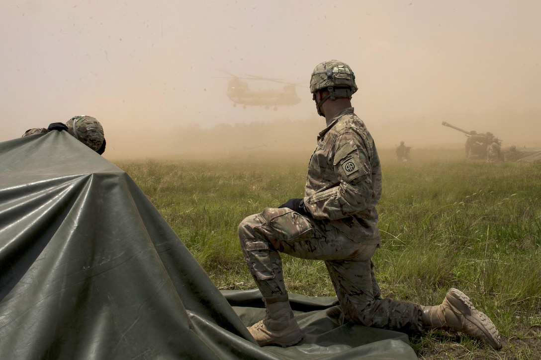 Soldiers watch as a CH-47 Chinook helicopter lands during exercise Crescent Reach 16 at Fort Bragg, N.C., May 26, 2016. Air Force photo by Airman 1st Class Sean Carnes