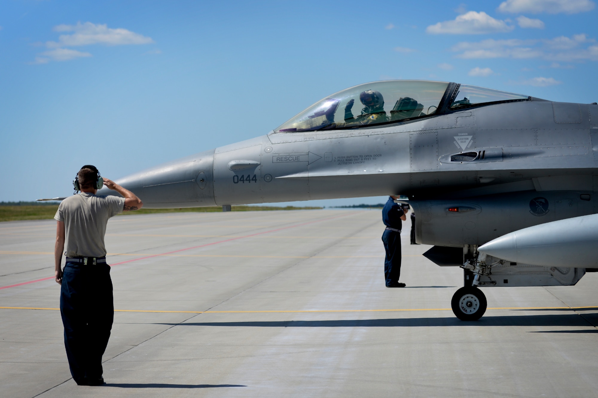 An Airman from the 31st Aircraft Maintenance Squadron finishes marshalling an F-16 Fighting Falcon from the 31st Fighter Wing, Aviano Air Base, Italy, to the taxi way for a sortie during Aviation Detachment Rotation 16-3 at Lask Air Base, Poland, June 7, 2016. While in Poland as part of regular quarterly training for AvDet Rotation 16-3, the participating units will also support exercises Baltic Operations 2016, Saber Strike 2016, Swift Response 2016 and Anakonda 2016, which will be occurring concurrently. (U.S. Air Force photo/Senior Airman Erin Babis)