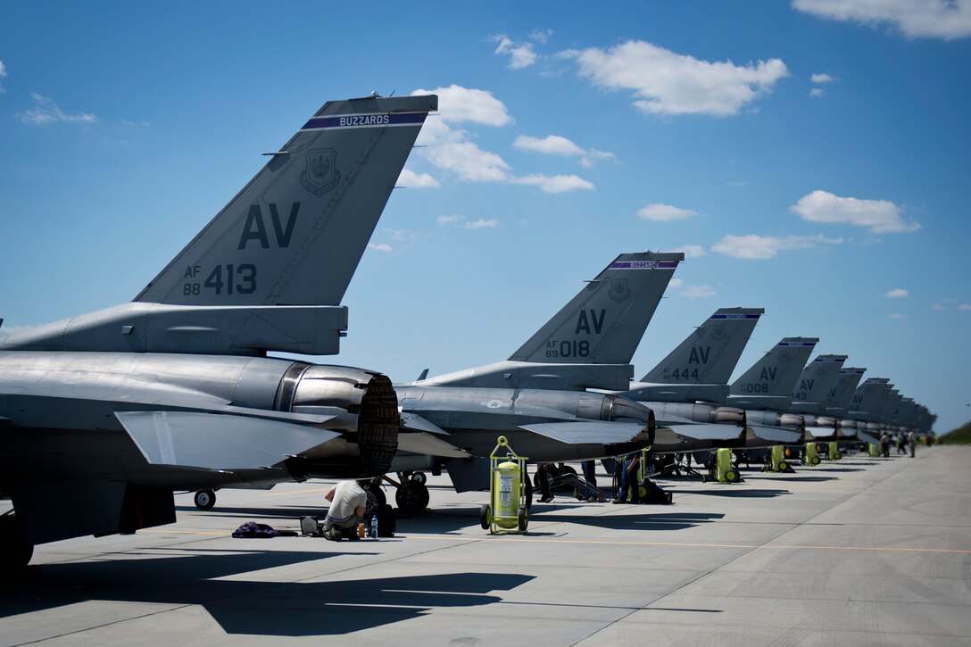 Airmen from the 31st Aircraft Maintenance Squadron prepare F-16 Fighting Falcons from the 31st Fighter Wing, Aviano Air Base, Italy, before a sortie during Aviation Detachment Rotation 16-3 at Lask Air Base, Poland, June 7, 2016. During this deployment 14 F-16 Fighting Falcons from the 31st FW, Aviano Air Base, Italy, six F-16s from the 138 FW, Tulsa Air National Guard, Okla., and support personnel will conduct bilateral training with Poland air forces to bolster interoperability between nations. (U.S. Air Force photo/Senior Airman Erin Babis) 