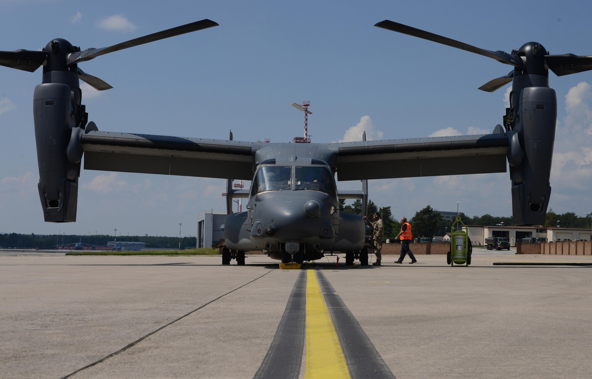 An Airman from the 7th Special Operations Squadron at Royal Air Force Mildenhall, England, prepares a CV-22 Osprey for departure at Ramstein Air Base, Germany, June 6, 2016. The CV-22 crew were returning to Mildenhall from the D-Day remembrance airdrops in Normandy, France, and stopped by Ramstein to pick up their squadron members returning from a deployment. (U.S. Air Force Photo/ Airman 1st Class Joshua Magbanua)