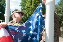 Pvt. 1st Class Austin Thompson, from Minford, Ohio, and Spc. Eric M. Johnson from Los Angeles, Ca., with the 554th Military Police Company from Stuttgart, Germany, raise the American flag for the opening ceremony of Exercise Anakonda 2016.