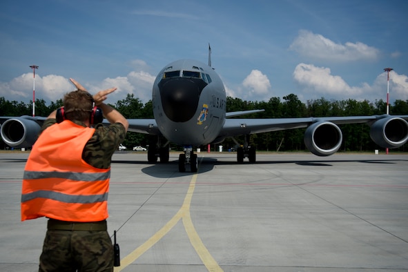 A Polish air force service member marshals a KC-135 from the 100th Air Refueling Wing, England, in preparation for exercise Baltic Operations 2016 at Powidz Air Base, Poland, June 2, 2016. Fifteen NATO and two partner nations will participate in the 44th iteration of the multinational maritime exercise BALTOPS 2016 in Estonia, Finland, Germany, Poland, Sweden, and throughout the Baltic Sea, June 3-19, 2016. (U.S. Air Force photo by Senior Airman Erin Babis/Released)