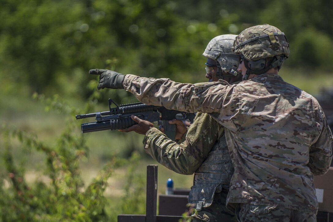 Range cadre point out targets downrange to a Soldier in his 6th week of Basic Combat Training with Co. A, 3rd Bn., 39th Inf. Reg., before firing the M203 Grenade Launcher on the U.S. Weapons Demonstration range at Fort Jackson, S.C., June 8. (U.S. Army photo by Sgt. 1st Class Brian Hamilton/ released)