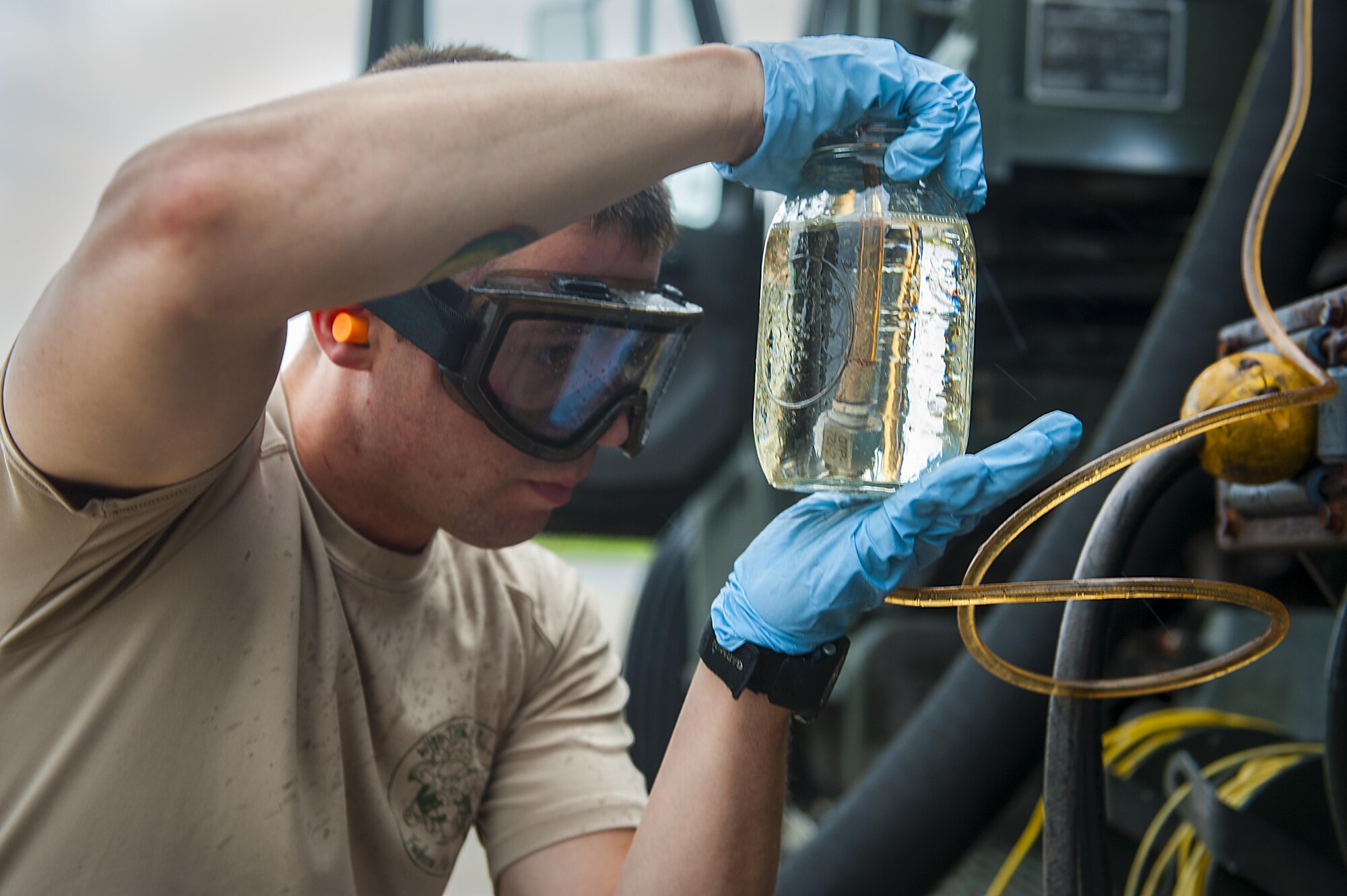 Staff Sgt. Nicholas Samuelson, an 18th Logistics Readiness Squadron fuels distribution supervisor, samples fuel from a pump house April 13, 2016, at Kadena Air Base, Japan. The fuel is pumped out of the ground by an R-12 refueling truck and tested for impurities before going into an aircraft. (U.S. Air Force photo/Airman 1st Class Corey M. Pettis)