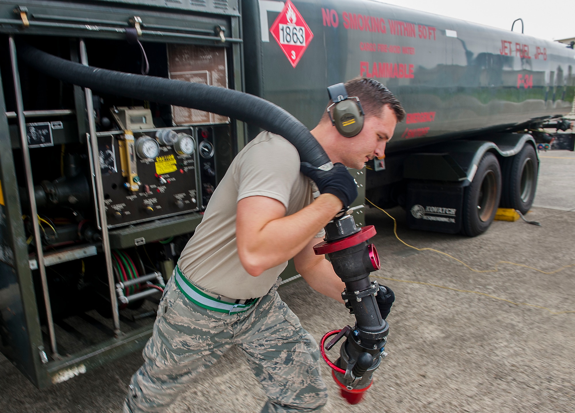 Airman 1st Class Terry Gilman, an 18th Logistics Readiness Squadron fuels distribution operator, pulls out a hose to refuel an aircraft April 13, 2016, at Kadena Air Base, Japan. Petroleum, oil and lubricant Airmen fuel the fight and are vital in keeping aircraft ready to go. (U.S. Air Force photo/Airman 1st Class Corey M. Pettis)