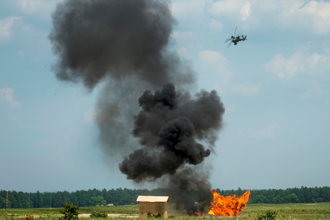 An Army AH-64 Apache helicopter conducts an attack fire mission during exercise Crescent Reach 16 at Fort Bragg, N.C., May 26, 2016. The helicopter crew is assigned to the 82nd Combat Aviation Brigade. Air Force photo by Airman 1st Class Sean Carnes