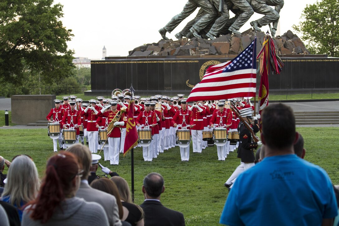 Approximately 40 educators from states east of the Mississippi River attend the Sunset Parade at the United States Marine Corps War Memorial in Arlington, Va., June 7. The Marine Corps Commandant's Own Drum and Bugle Corps and Silent Drill Platoon performed in the parade. During the 2016 Key Leaders and Educators Workshop, educators learn about the benefits of serving in the Marine Corps, enabling them to provide guidence based on firsthand expereince to their students.