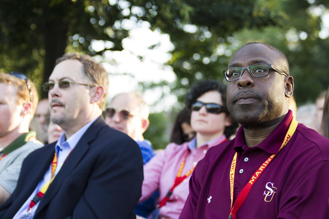 Sherman Wood attends the Sunset Parade at the United States Marine Corps War Memorial in Arlington, Va., June 7. Watching the performance is one of many events educators from states east of the Mississippi River experience during the week-long 2016 Key Leaders and Educators Workshop. Until it ends June 10, educators learn how Marine officers develop through programs and training, enabling educators to provide guidance based on firsthand experience to students interested in becoming Marine officers. Wood is the head football coach	for Salisbury University in Salisbury, Md. 

