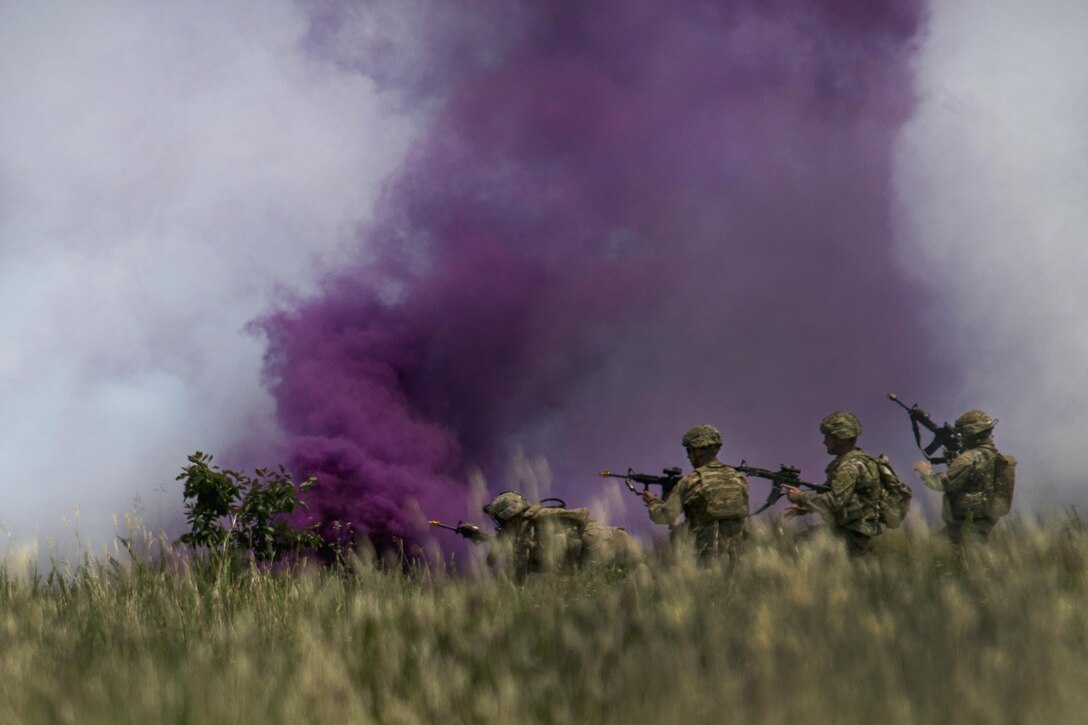 Soldiers advance on a target under the cover of smoke after participating in a fire mission during exercise Crescent Reach 16 at Fort Bragg, N.C., May 26, 2016. Air Force photo by Airman 1st Class Sean Carnes