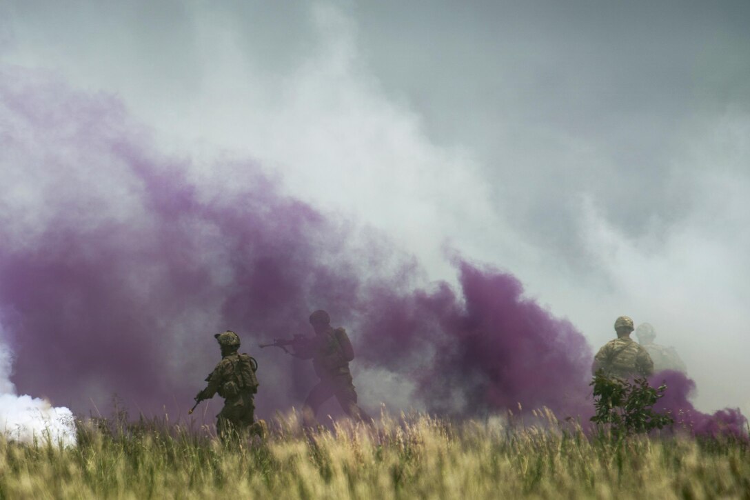 Soldiers maneuver to their next objective under the cover of smoke after participating in a fire mission during exercise Crescent Reach 16 at Fort Bragg, N.C., May 26, 2016. Air Force photo by Airman 1st Class Sean Carnes