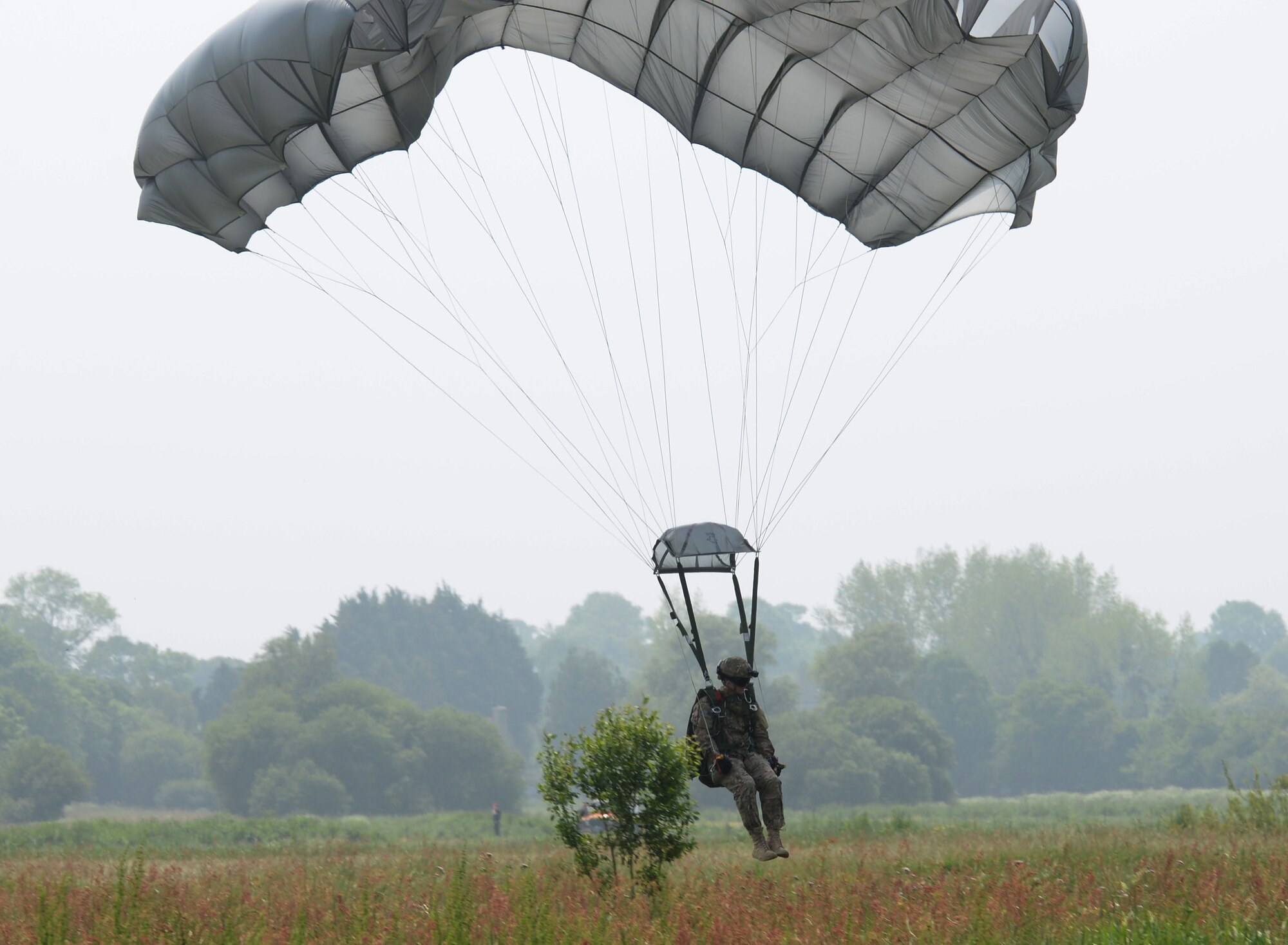 An Air Commando from the 321st Special Tactics Squadron lands in the drop zone after a high-altitude, low opening jump June 5, 2016, over Sainte-Mère-Église Normandy, France. The event was held in honor of the many airborne troops who lost their lives during the airdrop on D-Day, June 6, 1944. During World War II, the Battle of Normandy began on D-Day, when approximately 156,000 American, British and Canadian forces landed on five beaches along a 50-mile stretch of the coast of France’s Normandy region. (U.S. Air Force photo by Senior Airman Justine Rho/Released)