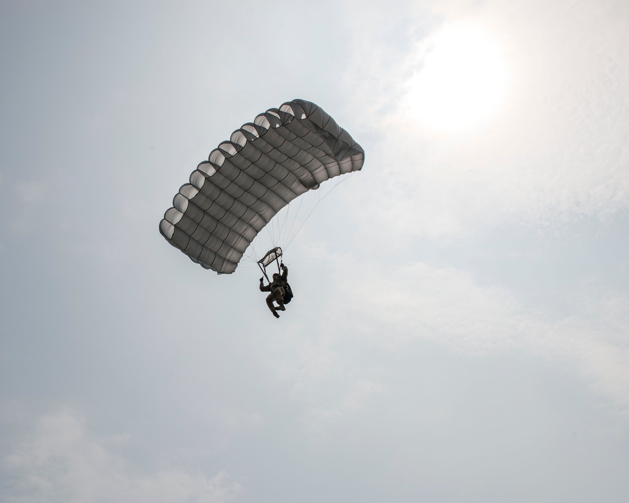 A U.S. air commando from the 321st Special Tactics Squadron approaches the drop zone after performing a high-altitude, low opening jump over Sainte-Mère-Église, France, June 5, 2016. The Airman was dropped from an MC-130J Commando II assigned to the 352d Special Operations Wing as part of a Normandy remembrance ceremony. During World War II, the Battle of Normandy began on D-Day, when about 156,000 American, British and Canadian forces landed on five beaches along a 50-mile stretch of the coast of France’s Normandy region. (U.S. Air Force photo by 1st Lt Chris Sullivan/Released)