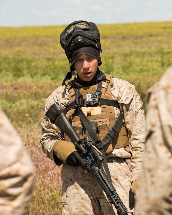 A U.S. Marine takes a breath after removing his mask at the Saylor Creek Range Complex, Idaho, May 26, 2016. The Marines used exercise rounds, similar to paint balls, to add realism to exercise scenarios. (U.S. Air Force photo by Airman Alaysia Berry/Released)