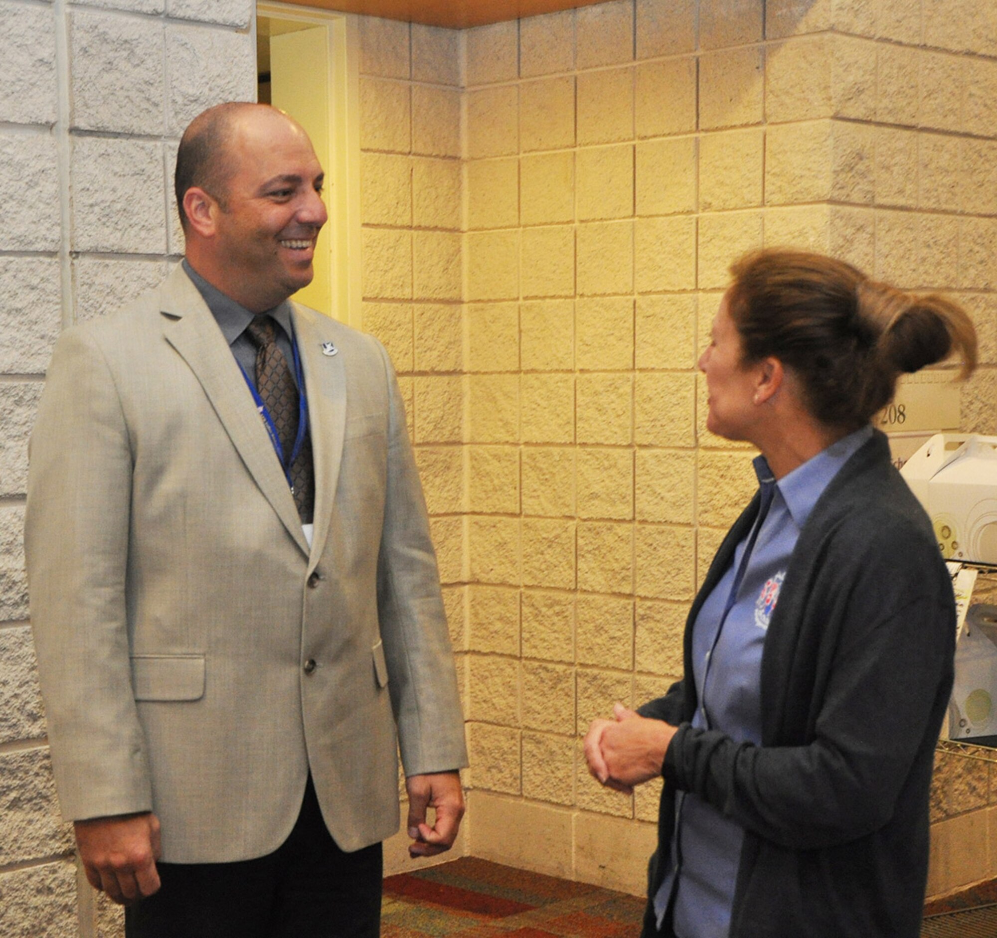 Air Force Reservist Master Sgt. Shawn Janowski of the 315th Security Forces Squadron, Joint Base Charleston, South Carolina, interacts with Jaimie Kwasegroch, youth program director, while providing security during the U.S. Air Force Reserve Yellow Ribbon event in Myrtle Beach, South Carolina May 22, 2016. The Yellow Ribbon Program promotes the well-being of reservists and their families by connecting them with resources before and after deployments. (U.S Air Force photo/Master Sgt. James Branch)